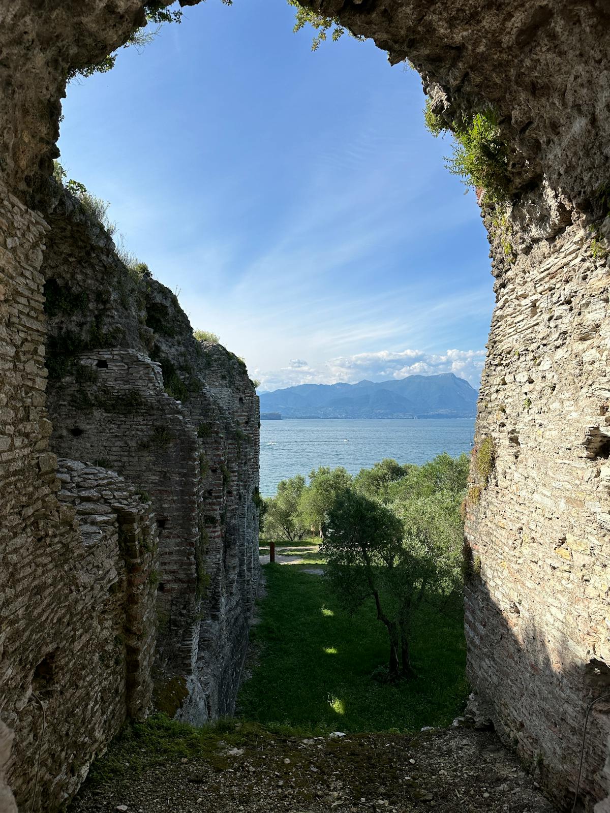 Stone ruins of the Roman-era Catullus Grottoes on Sirmione's peninsula above the lake